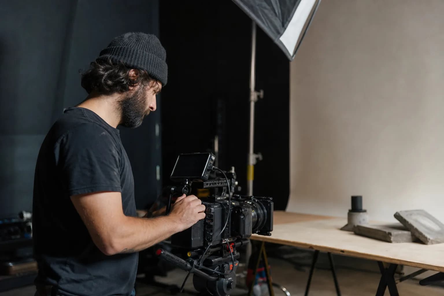 Filmmaker operating a cinema camera on a small professional set.